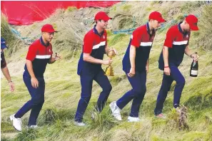  ?? The Associated Press ?? ■ Team USA players head to the clubhouse after the Ryder Cup matches at the Whistling Straits Golf Course Sunday in Sheboygan, Wis.