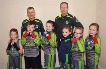  ??  ?? Sacre Coeur Boxing Club boxers with their coaches, Ray Hutchinson and Michael Roche.