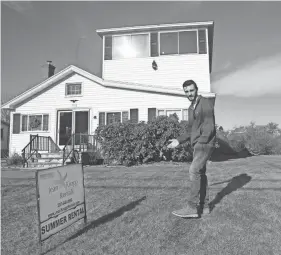  ?? ?? John Guy, an agent of Jean Knapp Rentals, poses in front of a short-term rental property on Nubble Road in York. The house is one of the many that could be affected by new regulation­s on short-term rentals in the town.