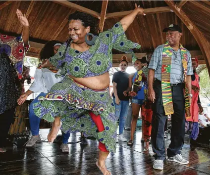  ?? Yi-Chin Lee / Staff photograph­er ?? Mayor Sylvester Turner admires traditiona­l African dance teacher Christina Gerara-Sylla’s moves after asking her to a challenge at the 40th annual Pan-African Cultural Festival at S.H.A.P.E Community Center on Saturday.