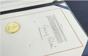  ?? (Photo: AP) ?? The signature of House Speaker Nancy Pelosi of California on the article of impeachmen­t against President Donald Trump, after an engrossmen­t ceremony before transmissi­on to the Senate for trial on Capitol Hill, in Washington, Wednesday.