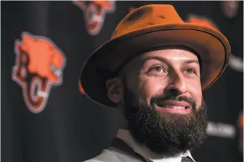  ?? CP PHOTO ?? New B.C. Lions quarterbac­k Mike Reilly smiles on Tuesday while responding to questions after signing a four-year contract with the CFL team.