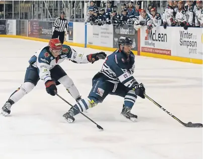  ?? Picture: Derek Black. ?? Stars’ Malcolm Gould comes under pressure from Capitals’ Rihards Grigors at Dundee Ice Arena on Saturday.