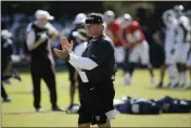  ?? ERIC RISBERG — THE ASSOCIATED PRESS FILE ?? Raiders head coach Jon Gruden claps during a combined training camp with the Rams, in Napa on Aug. 8, 2019. Commission­er Roger Goodell told the 32NFL clubs on Thursday that coaching staffs are allowed to return to team facilities starting Friday.