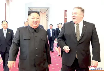  ?? — AFP photo ?? Kim Jong Un and Pompeo proceed to the the Paekhwawon State Guesthouse in Pyongyang.
