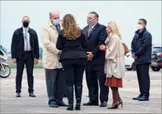  ?? Patrick Semansky / Getty Images ?? Secretary of State Mike Pompeo, third from right, and his wife Susan, third from left, speak with Jacques Jouslin de Noray of Frances Ministry of Foreign Affairs and U.S. Ambassador to France Jamie Mccourt after stepping off a plane in France on Saturday at the start of a 10-day trip to Europe and the Middle East.