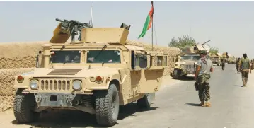  ?? (Abdul Malik/Reuters) ?? AFGHAN NATIONAL ARMY troops arrive in the Nad Ali district of Helmand province, southern Afghanista­n, yesterday.