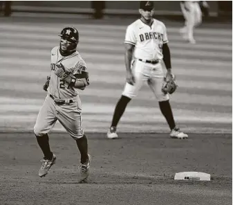  ?? Norm Hall / Getty Images ?? Jose Altuve hit a solo homer in the sixth inning for the Astros, who lost 5-4 to the Diamondbac­ks on Thursday. Altuve came into the game 3 for 34 but went 3 for 4 with three runs scored.