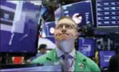  ?? RICHARD DREW — THE ASSOCIATED PRESS FILE ?? Trader Ryan Falvey works on the floor of the New York Stock Exchange. Stocks closed lower on Wall Street Wednesday, weighed down by a mixed batch of corporate earnings from big retailers and lingering uncertaint­y over the trade spat between the U.S. and China.