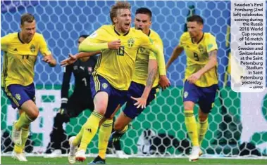  ?? AFPPIX ?? Sweden’s Emil Forsberg (2nd left) celebrates scoring during the Russia 2018 World Cup round of 16 match between Sweden and Switzerlan­d at the Saint Petersburg Stadium in Saint Petersburg yesterday. – starting XI months before the tournament and he did...