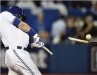  ?? STEVE RUSSELL/TORONTO STAR AND FRANK GUNN/THE CANADIAN PRESS ?? Texas outfielder Delino DeShields, left, scores his team’s second run against Toronto, while the Jays’ Justin Smoak has his bat sawed off. Smoak went hitless in four at-bats.