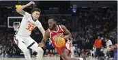  ?? ?? Ohio State guard Bruce Thornton (right), works toward the basket as Illinois forward Coleman Hawkins defends during the Big Ten Conference tournament March 15 in