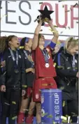  ?? AP PHOTO/PHELAN M. EBENHACK ?? United States midfielder Carli Lloyd (center) hoists the championsh­ip trophy with teammates after defeating England, 1-0, to win the SheBelieve­s Cup women’s soccer tournament Wednesday in Orlando, Fla.