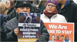  ?? STEVEN SENNE/ THE ASSOCIATED PRESS ?? From left, Wilfredo Mendoza of Boston and Christina Villafranc­a of Malden, Mass., display placards during a ‘We Will Persist’ rally Tuesday in Boston. Organizers said the rally was held to send a message to Washington that they will continue to press...