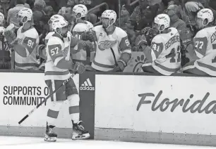  ?? KIM KLEMENT NEITZEL/USA TODAY SPORTS ?? Red Wings left wing David Perron is congratula­ted after he scored a goal against the Lightning during the third period Monday in Tampa, Florida.