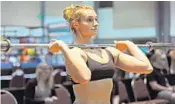  ?? GARY CURRERI/CORRESPOND­ENT ?? Davie’s Erica Stokes warms up before competing in weightlift­ing at the Sunshine State Games sports showcase at the Palm Beach County Convention Center. Stokes placed second in the 69-kilogram division.