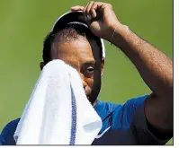  ?? AP/CHARLIE RIEDEL ?? Tiger Woods worked his way into contention Saturday at Bellerive Country Club in St. Louis, firing a 4-under 66. He is four strokes behind the leader.