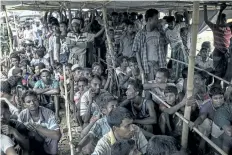  ?? FRED DUFOUR/GETTY IMAGES ?? Rohingya refugees wait in line for food at the Thangkhali refugee camp in the Bangladesh­i district of Ukhia on Tuesday.