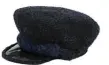  ??  ?? Midnight blue and black cap in iridescent wool and PVC, Chanel