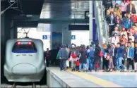  ?? TANG KE / FOR CHINA DAILY ?? Passengers board a high-speed train in Yantai, Shandong province, on April 16.