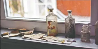  ??  ?? Glass bottles and pieces of china were found during renovation at the house.