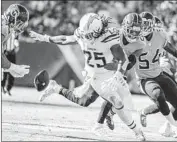  ?? Robert Gauthier Los Angeles Times ?? CHARGERS running back Melvin Gordon looks to recover his own fumble against the Tennessee Titans.