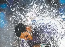  ?? Helen H. Richardson, The Denver Post ?? Colorado’s Nolan Arenado gets doused with water after his walkoff, two-run homer against the Arizona Diamondbac­ks on Wednesday at Coors Field.