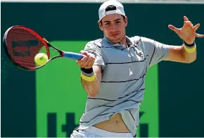  ??  ?? Miami nice: Isner hits a forehand on his way to the title