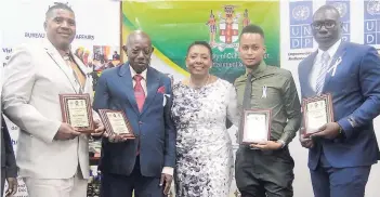  ?? PHOTO BY PAUL WILLIAMS ?? Olivia Grange (centre), minister of culture, gender, entertainm­ent and sport, is surrounded by the recipients of the Amazing Men Award: (from left) Wayne Bartley, Earle Malcolm, Nicholas Campbell and Wayne Williams.