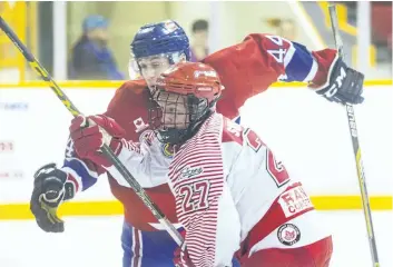  ?? JULIE JOCSAK/POSTMEDIA NEWS ?? Lucas Smilsky of the St. Catharines Falcons and Niochlas Boehmer of the Welland Jr. Canadians fight for the puck at the Jack Gatecliff Arena in St. Catharines in this file photo.