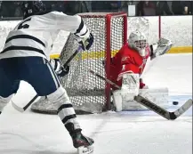  ?? CHRIS CHRISTO — BOSTON HERALD ?? MIDDLETON, MA - February 13, 2023: Catholic Memorial’s goalie Owen Watson tries to stop a centering pass by St. John’s Ben McGilvray.