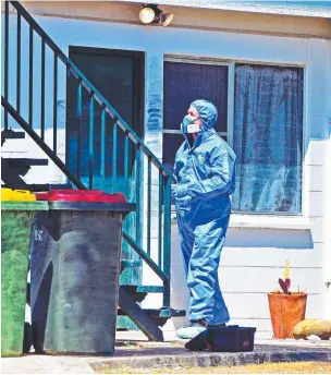  ?? Pictures: ZAK SIMMONDS ?? INQUIRY LAUNCHED: A police investigat­or at the Conroy St house and ( right) Lynn Godbold, the wife of victim Lance.