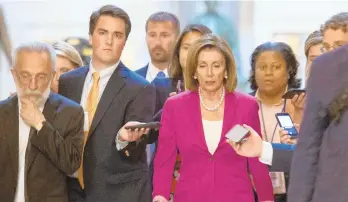  ?? ANDREW CABALLERO-REYNOLDS/GETTY-AFP ?? House Speaker Nancy Pelosi walks with reporters before the chamber voted to condemn President Donald Trump’s tweets about four congresswo­men as racist.