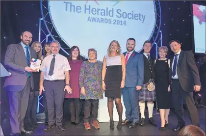  ??  ?? TRIUMPH: ENABLE Works, part of ENABLE Scotland, receive the Team of the Year award from Dr Mary Hepburn, sixth from left, last year.