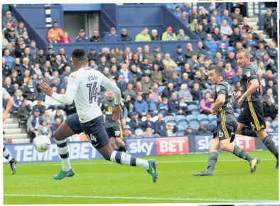 ??  ?? George Honeyman scores the opening goal against Preston at Deepdale and (right) is congratula­ted by his team-mates