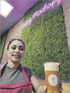  ?? ROMAN FLORES PHOTO ?? A cashier, “Jessica,” smiles as she hands off a Thai boba tea with cheese foam at Happy Machapy boba tea shop, on Wednesday, March 27, in El Centro.