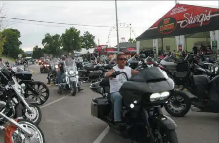  ?? STEPHEN GROVES — THE ASSOCIATED PRESS ?? Bikers ride through downtown Sturgis, S.D., on Friday with few wearing masks or practicing social distancing. About 250,000 people are expected to visit the town during the 10-day rally.