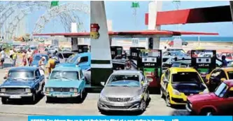  ?? — AFP ?? HAVANA: Car drivers line up to get their tanks filled at a gas station in Havana.