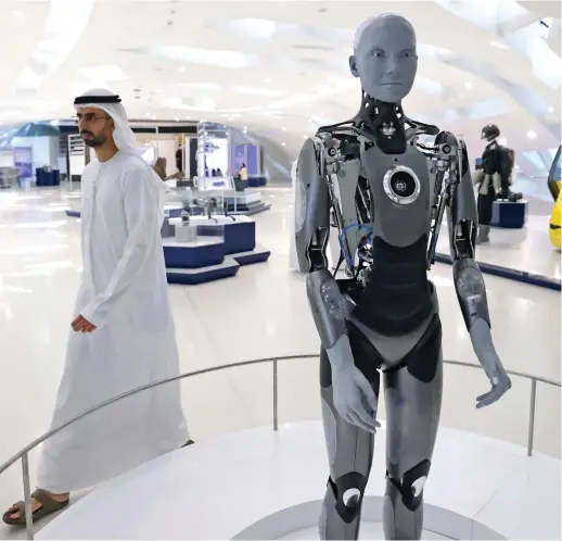  ?? AFP ?? The AI-powered Ameca, made by the UK-based Engineered
Arts and described as a perfect platform for human-robot interactio­n, greets visitors at Dubai’s Museum of the Future.