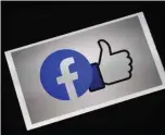  ?? — AFP ?? A Facebook App logo is displayed on a smartphone in Arlington, Virginia. Facebook reached out to businesses struggling to survive the pandemic with free tools for creating online “Shops” at the social network and Instagram.