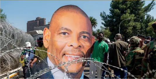  ??  ?? Above: A cut-out figure of ANC secretary general Ace Magashule erected by supporters outside Bloemfonte­in Magistrate Court.