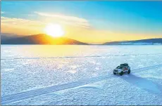  ??  ?? Wu’s modified Toyota Landcruise­r skates across an arctic plain at sunset, as the Zhenjiang explorer nears his destinatio­n.