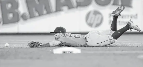  ?? Karen Warren / Houston Chronicle ?? Astros second baseman Jose Altuve can’t corral a grounder by Didi Gregorius, who plated Aaron Judge from third with two outs to put the Yanks up 4-0 in the fifth.