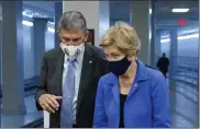  ?? PATRICK SEMANSKY / AP FILE ?? Sen. Joe Manchin, D-W.Va., left, speaks with Sen. Elizabeth Warren, D-Mass., on Wednesday.