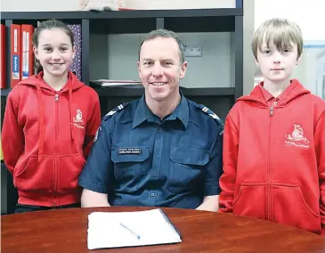  ??  ?? Trafalgar Primary School students Mackenzie Rankin and Thomas Nelson learn talk about local policing with Leading Senior Constable Kevin Scouller.