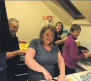  ??  ?? Tobermory RNLI crew, fundraiser­s and family prepare 90kg of potatoes for the fish supper.