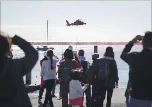  ?? DAI SUGANO — STAFF PHOTOGRAPH­ER ?? The U.S. Coast Guard demonstrat­es how they rescue people from the water on Wednesday during a ribbon-cutting ceremony for four life ring stations installed at beaches in Half Moon Bay.