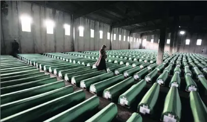 ?? PICTURE: REUTERS ?? A Bosnian Muslim woman examines coffins in Potocari, near Srebrenica, in July 2011.