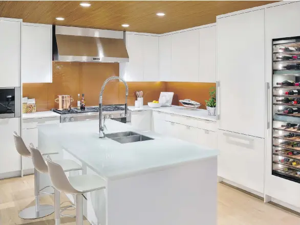  ??  ?? The show suite kitchen for Horseshoe Bay West Vancouver is a clean and contempora­ry space fitted with matte lacquer cabinetry and under-cabinet lighting.