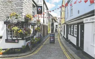  ??  ?? A street is pictured from the Barbican quarter. Many of the buildings here date from the
time of the Mayflower.